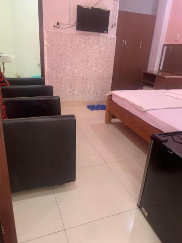 a room with two beds and a flat screen tv at Khách sạn Ánh Nguyệt 1 in Ho Chi Minh City