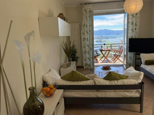 a living room with a couch and a balcony at Miralago in Stresa
