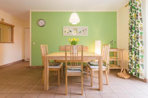 a dining room with a wooden table and chairs at Ostseeresidenz - Whg 14 in Zingst