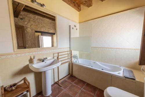 a bathroom with a sink and a bath tub at La Hacendera Entre Hoces - 20-28pax-10 hab con baños en suite in Maderuelo