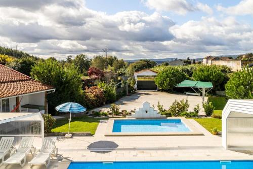 a backyard with a swimming pool and a house at 9Arches in Vila Nova de Poiares