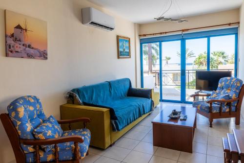 a living room with a couch and two chairs at Arsinoe Beach Village Block 9 in Polis Chrysochous