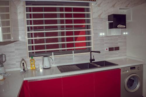 a kitchen counter with a sink and a window at Luxe Isle by Harolty, East Legon in Accra