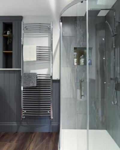 a bathroom with a shower with a glass door at Exceptional Holiday Home 5 with Hot Tub Pickering in Pickering