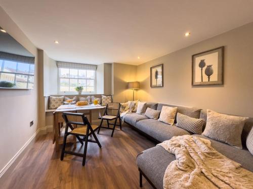 a living room with a couch and a table at Exceptional Holiday Home 5 with Hot Tub Pickering in Pickering