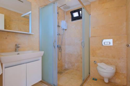 a bathroom with a shower and a sink and a toilet at Villa Sheyma in Kalkan