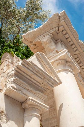 astration of a stone building with trees in the background at Villa Geba Boutique Hotel in Sveti Stefan