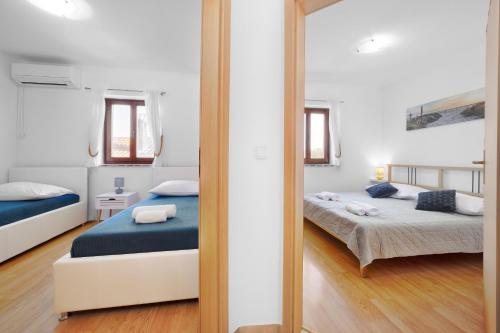 a mirror reflection of a bedroom with two beds at Villa Vrsar in Vrsar