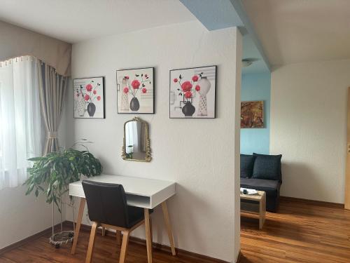 a living room with a table and pictures on the wall at Käthe-Kollwitz - Straße 54, F3 in Altenburg