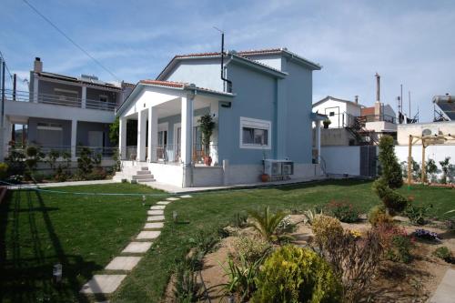 a house with a lawn in front of it at Salt & wave in Volos