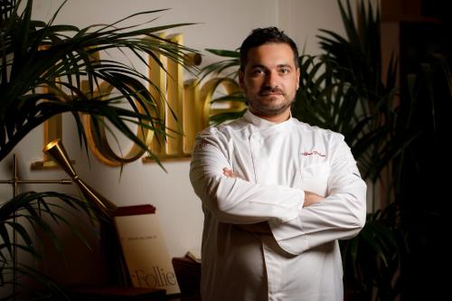 a man in a chef uniform standing with his arms crossed at Villa Agrippina Gran Meliá – The Leading Hotels of the World in Rome