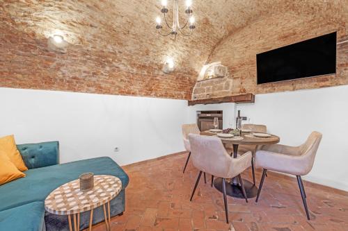 a living room with a couch and a table with chairs at Villa Vrsar in Vrsar