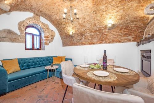 a living room with a table and a couch at Villa Vrsar in Vrsar