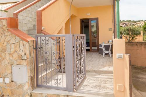 a gate to a house with a patio at Hotel Sa Suergia in Villasimius