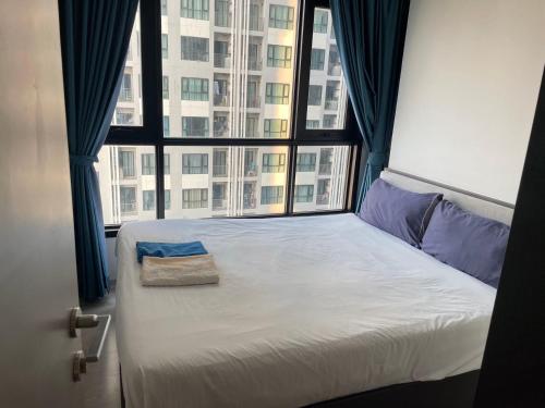 a bed in a room with a large window at The Base Central Pattaya Super condo in Pattaya Central