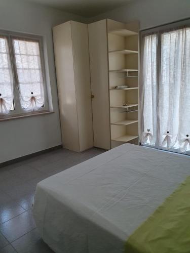 a bedroom with a large bed and two windows at CASA PRIMO in Villa Rosa
