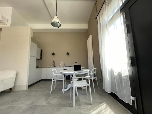 a kitchen with a table and chairs in a room at TRETRE in Bologna