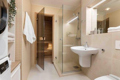 a bathroom with a glass shower and a sink at Amazing sea views - W207 in Tallinn
