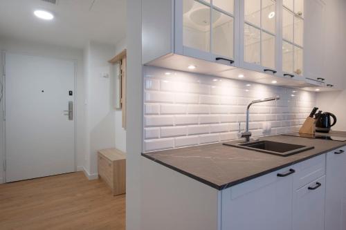 a kitchen with a sink and white walls at Apartament Deluxe Sea View PINEA 621 in Pobierowo
