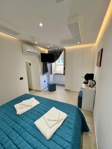 a bedroom with a blue bed with two towels on it at IL FILO DI ARIANNA in Bari