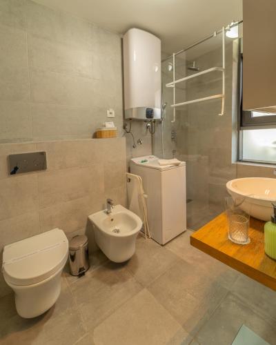 a bathroom with a toilet and a sink at Amare Luxury Apartments in Budva