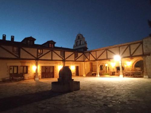 a large building with a courtyard at night at La Cerca Entre Hoces-10-20pax-Amplios espacios comunes in Sebúlcor