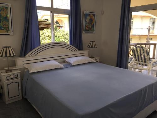 a bedroom with a large bed and a window at Studio Manguillier in Trou dʼ Eau Douce