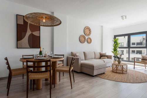 a living room with a couch and a table at Casa Isa - Luxury Penthouse Seaview in Estepona
