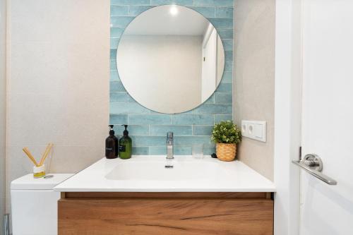 y baño con lavabo y espejo. en Lodging Apartments Beach Studio 41 en Barcelona