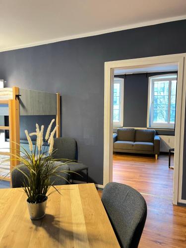 a living room with a table and a couch at Blue Doors Hostel KTV in Rostock