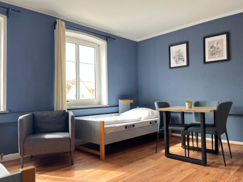 a hospital room with a bed and a table at Blue Doors Hostel KTV in Rostock