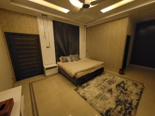 a bedroom with a bed and a tv in a room at edge villas in Islamabad