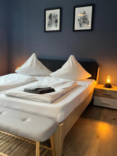 a bed in a room with two white beds at Blue Doors Hostel KTV in Rostock