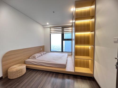 a small bedroom with a bed and a window at 2702 HHG Apartment in Hai Phong