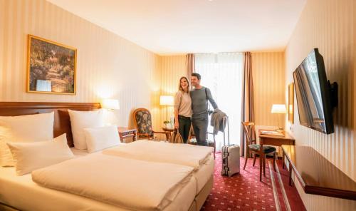 a man and a woman standing in a hotel room at Alt Lohbrügger Hof in Hamburg