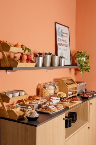 a buffet with various food items on a counter at Hotel Altevie in Guardiagrele