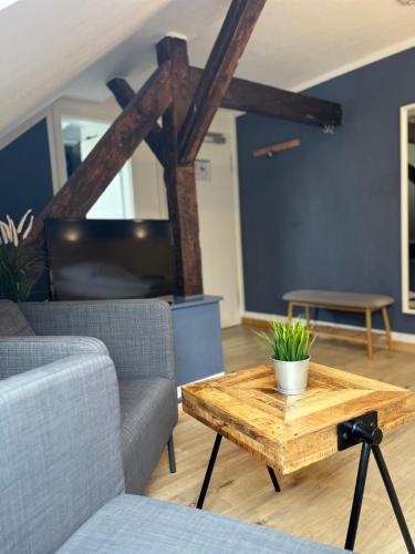 a living room with a couch and a coffee table at Blue Doors Hostel KTV in Rostock
