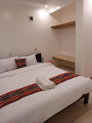 a bedroom with two beds with towels on it at COMFORT E SUITES in Nairobi