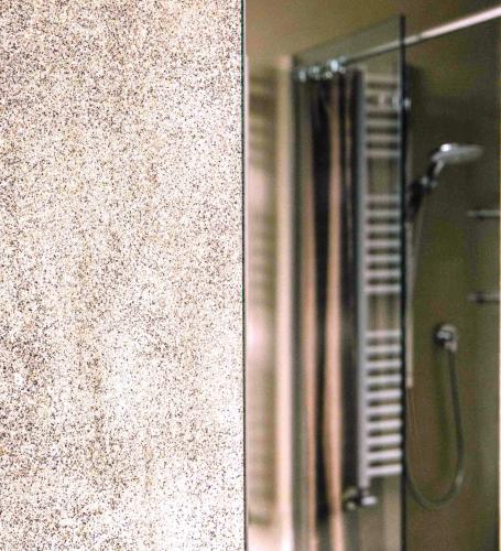 a bathroom with a shower with a glass door at Tenuta Moncarlino in Morsasco