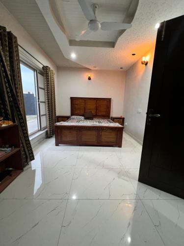 a bedroom with a bed and a large window at Deal of the Month Vacation Home in Rawalpindi