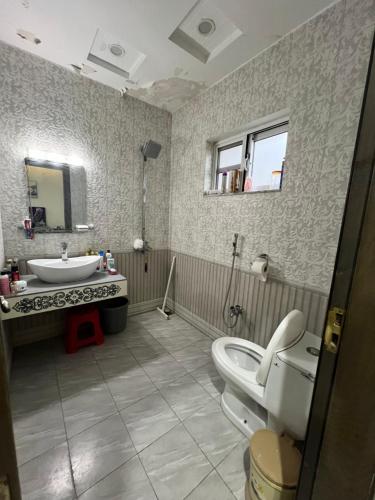 a bathroom with a sink and a toilet in it at Deal of the Month Vacation Home in Rawalpindi