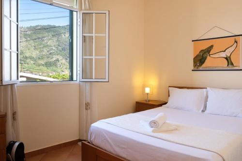 a bedroom with a bed and a large window at GuestReady - Hikers Haven in Faial