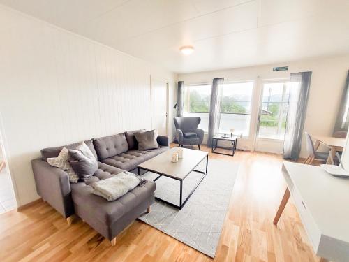 a living room with a couch and a table at Destination Senja - Skaland in Skaland