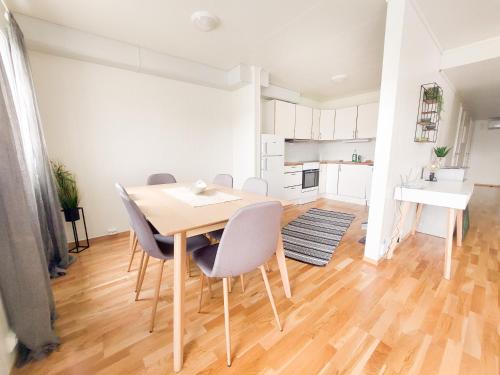 a kitchen and dining room with a table and chairs at Destination Senja - Skaland in Skaland