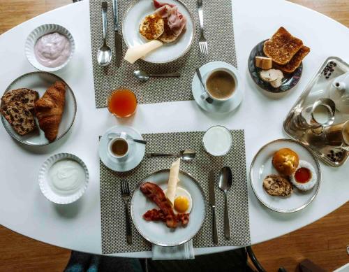 a white table with plates of breakfast foods and coffee at Tenuta Moncarlino in Morsasco