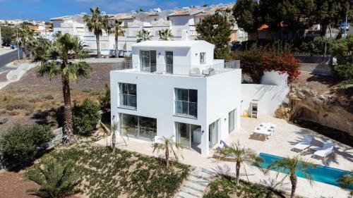 an aerial view of a white house with a swimming pool at GuestReady - A delightful stay in Porto Santo in Porto Santo