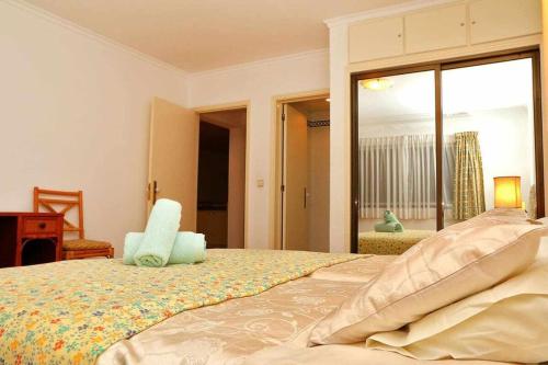 a bedroom with a bed and a large window at Formosa Sunset - Em frente à praia com wifi in Funchal