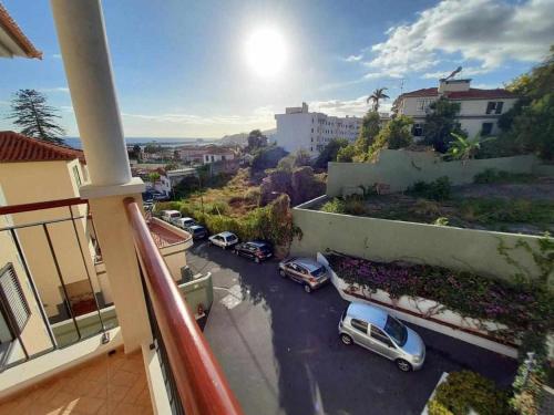a balcony with cars parked in a parking lot at GuestReady - Nora Premium in Funchal