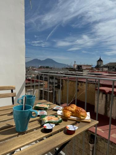 a table with bread and pastries on top of a roof at FP Suite in Naples