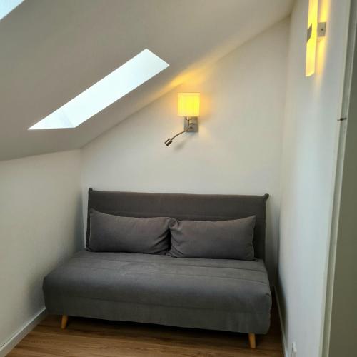 a couch in the corner of a room with a skylight at Ferienhaus Finca de vida y luz in Auderath